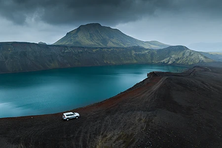 Toyota Landcruiser 150 4x4 diesel next to green lake in Iceland